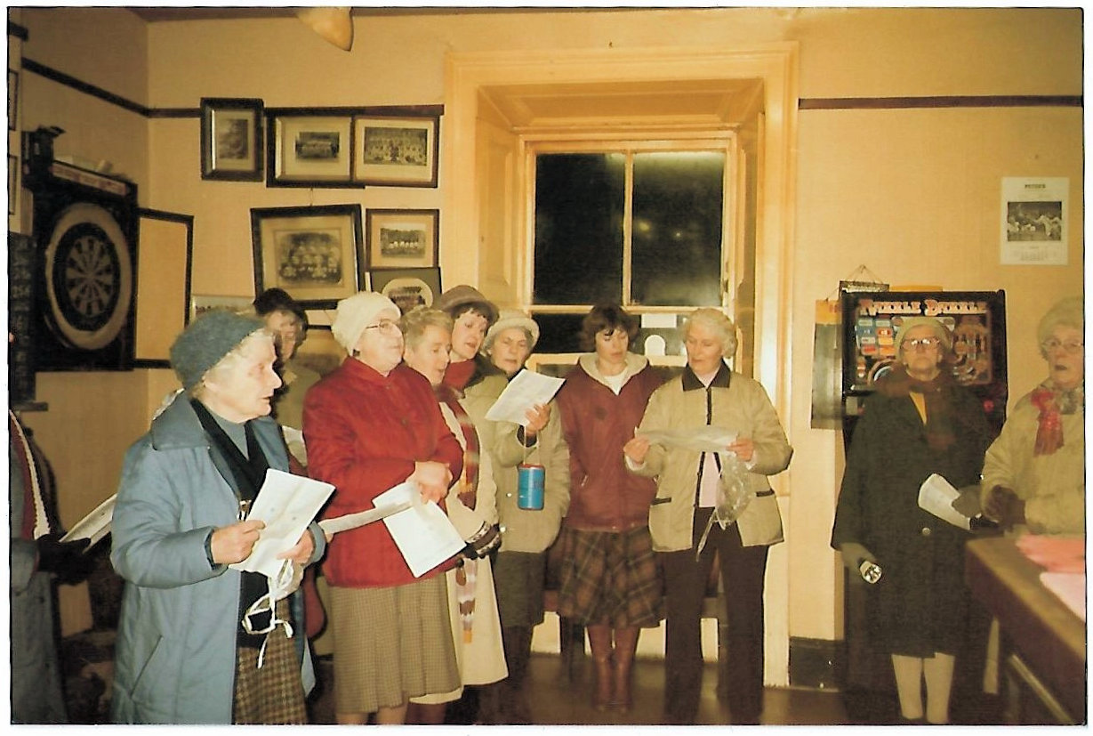 Interior of White Hart with WI carol singers C1980